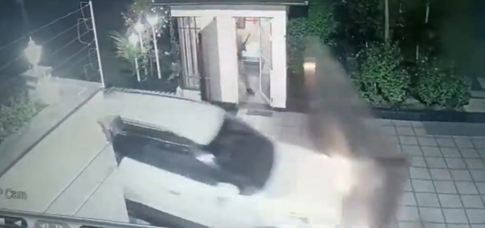 A vehicle has impacted a residential entry gate at night